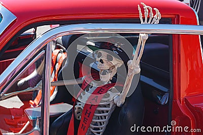 Skeleton driver in cool car invites Halloween riders Editorial Stock Photo